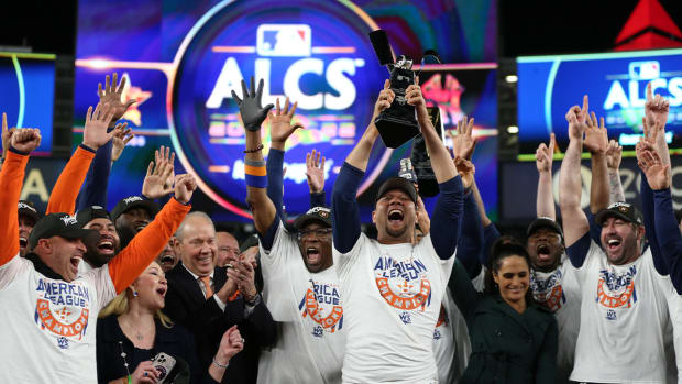 Oct 23, 2022; Bronx, New York, USA; Houston Astros first baseman Yuli Gurriel (10) holds the trophy after defeating the New York Yankees during game four of the ALCS for the 2022 MLB Playoffs at Yankee Stadium.