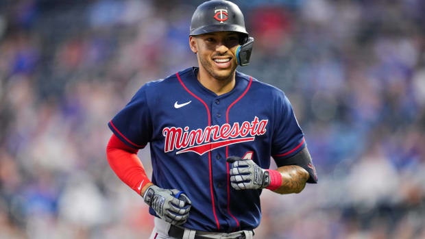 Twins shortstop Carlos Correa runs off the field after recording an out in a game.