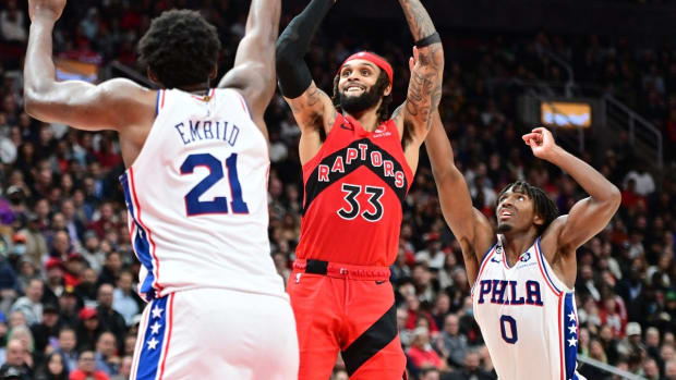 Oct 26, 2022; Toronto, Ontario, CAN; Toronto Raptors guard Gary Trent Jr. (33) shoots the ball over Philadelphia 76ers center Joel Embiid (21) and guard Tyrese Maxey (0) in the second half at Scotiabank Arena. Mandatory Credit: Dan Hamilton-USA TODAY Sports