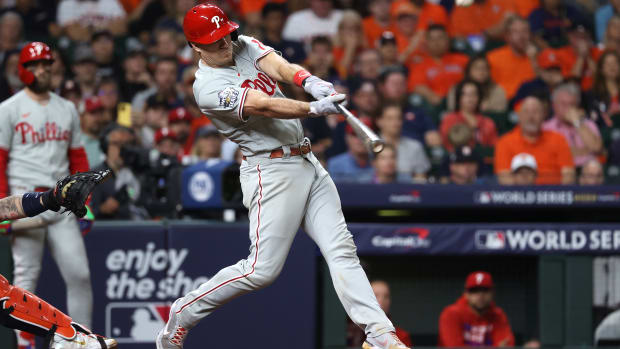 Phillies catcher J.T. Realmuto hits a home run during the tenth inning against the Houston Astros in game one of the 2022 World Series at Minute Maid Park.