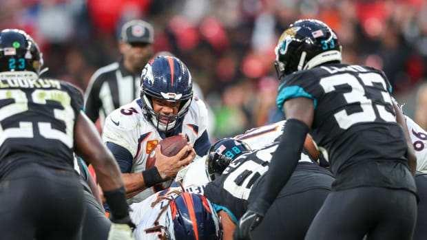 Denver Broncos quarterback Russell Wilson (3) stretches from first down against the Jacksonville Jaguars in the forth quarter during an NFL International Series game at Wembley Stadium.