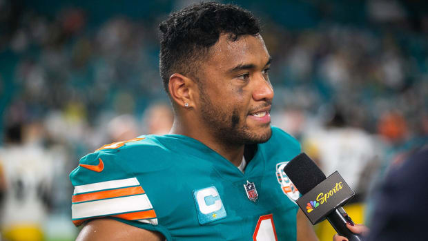 Tua Tagovailoa answers a question in a TV interview following a Dolphins win.