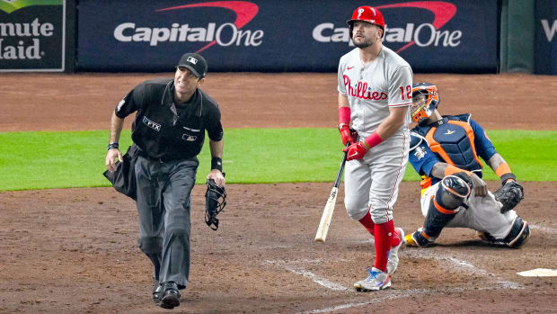 Phillies left fielder Kyle Schwarber and home plate umpire Pat Hoberg watch as a ball hit by Schwarber goes foul.
