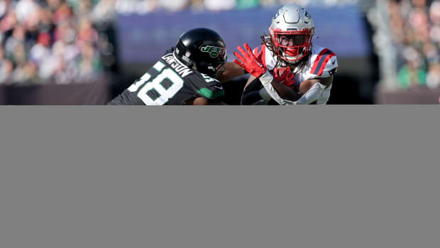 Oct 30, 2022; East Rutherford, New Jersey, USA; New England Patriots running back Rhamondre Stevenson (38) runs with the ball against New York Jets defensive end Carl Lawson (58) during the second quarter at MetLife Stadium.