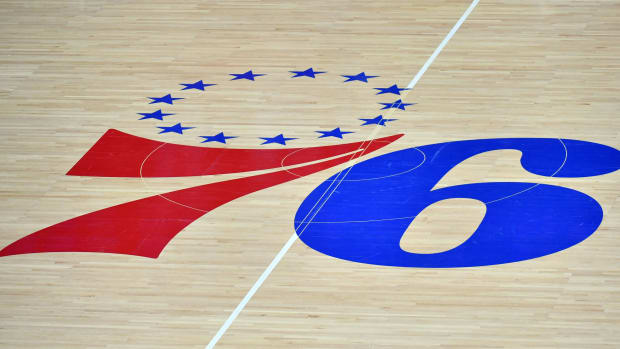 An overhead view of the 76ers logo at mid-court.