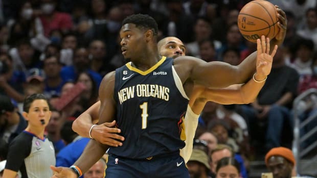Oct 30, 2022; Los Angeles, California, USA; New Orleans Pelicans forward Zion Williamson (1) keeps the ball out of reach of Los Angeles Clippers forward Nicolas Batum (33) in the second half at Crypto.com Arena.