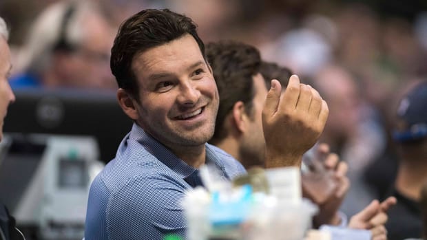 Cowboys quarterback Tony Romo watches the game between the Mavericks and the Celtics at the American Airlines Center.