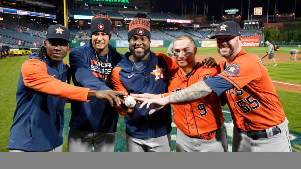 The four Astros pitchers—Cristian Javier, Bryan Abreu, Rafael Montero and Ryan Pressly—who threw a combined no-hitter in the World Series and their catcher Christian Vázquez pose for a photo.
