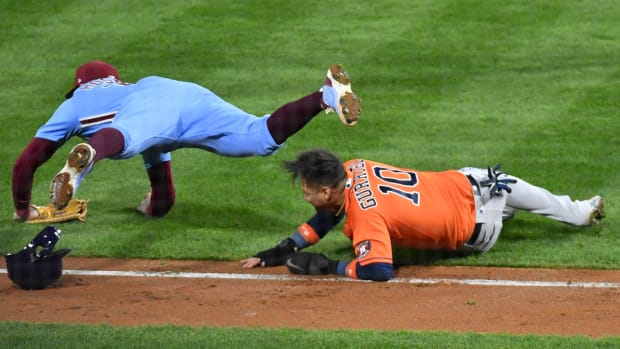 Phillies first baseman Rhys Hoskins trips over Astros first baseman Yuli Gurriel during Game 5 of the 2022 World Series.