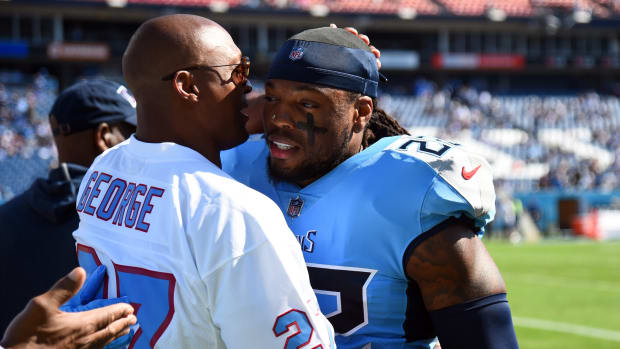 Former Tennessee Titans running back Eddie George talks with running back Derrick Henry (22) before the game against the Indianapolis Colts at Nissan Stadium.