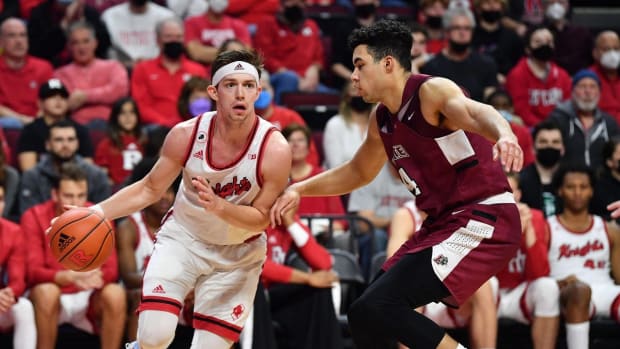 Nov 22, 2021; Piscataway, New Jersey, USA; Rutgers Scarlet Knights guard Paul Mulcahy (4) dribbles the ball against Lafayette Leopards forward Kyle Jenkins (14) during the second half at Jersey Mike's Arena. Mandatory Credit: Catalina Fragoso-USA TODAY Sports