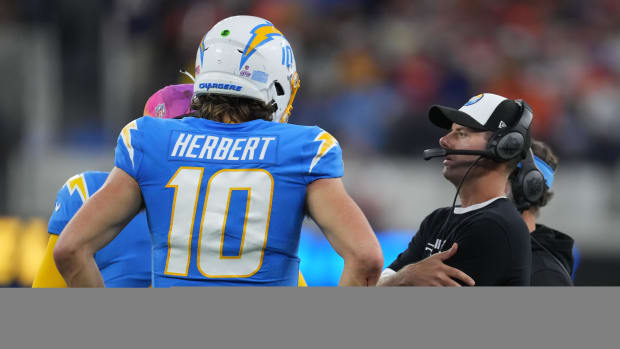 Oct 17, 2022; Inglewood, California, USA; Los Angeles Chargers head coach Brandon Staley (left) talks with quarterback Justin Herbert (10) during the game against the Denver Broncos at SoFi Stadium. Mandatory Credit: Kirby Lee-USA TODAY Sports