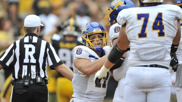 Sep 3, 2022; Iowa City, Iowa, USA; South Dakota State Jackrabbits quarterback Mark Gronowski (11) is picked up by teammates after a sack for a safety against the Iowa Hawkeyes during the fourth quarter at Kinnick Stadium. Mandatory Credit: Jeffrey Becker-USA TODAY Sports