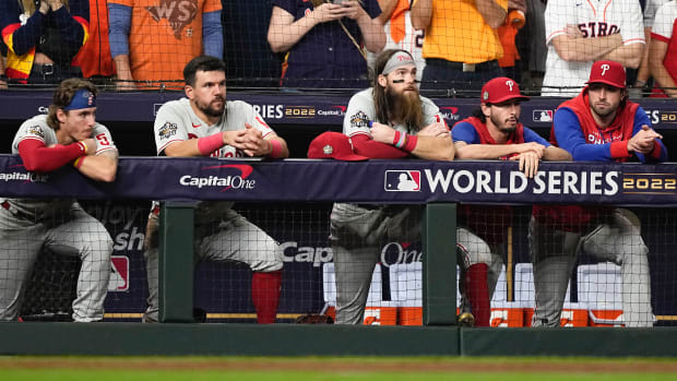 A group of Phillies stand in the dugout during Game 6 of the World Series