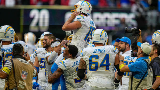 Nov 6, 2022; Atlanta, Georgia, USA; Los Angeles Chargers place kicker Cameron Dicker (15) is lifted by his teammates after kicking the game winning field goal against the Atlanta Falcons during the second half at Mercedes-Benz Stadium. Mandatory Credit: Dale Zanine-USA TODAY Sports