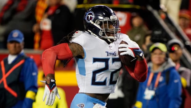 Tennessee Titans running back Derrick Henry (22) rushes for a first down while pursued by Kansas City Chiefs safety Justin Reid (20) during the second quarter at GEHA Field at Arrowhead Stadium Sunday, Nov. 6, 2022, in Kansas City, Mo.