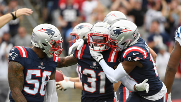 Nov 6, 2022; Foxborough, Massachusetts, USA; New England Patriots cornerback Jonathan Jones (31) is congratulated by wide receiver Matthew Slater (18) and linebacker Anfernee Jennings (58) after blocking a punt during the first half against the Indianapolis Colts at Gillette Stadium.