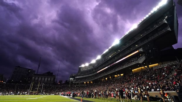 The sky turns a purple hue in the fourth quarter during a college football game between the Navy Midshipmen and the Cincinnati Bearcats, Saturday, Nov. 5, 2022, at Nippert Stadium in Cincinnati. The Cincinnati Bearcats won, 20-10. Ncaaf Navy Midshipmen At Cincinnati Bearcats Nov 6 0869