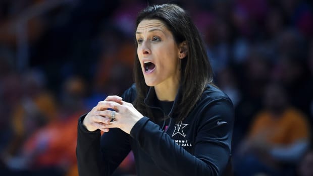 Vanderbilt coach Stephanie White signals to her players on the court.