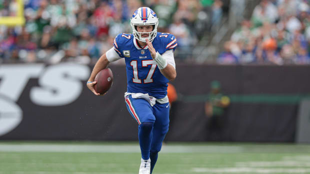 Nov 6, 2022; East Rutherford, New Jersey, USA; Buffalo Bills quarterback Josh Allen (17) carries the ball for a rushing touchdown during the first half against the New York Jets at MetLife Stadium.