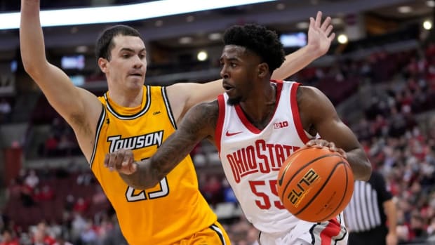 Ohio State Buckeyes guard Jamari Wheeler (55) dribbles around Towson Tigers guard Nicolas Timberlake (25) during the first half of the NCAA men's basketball game at Value City Arena in Columbus on Wednesday, Dec. 8, 2021.

Towson Tigers At Ohio State Buckeyes Basketball