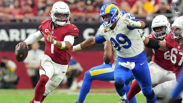 Sep 25, 2022; Glendale, AZ, USA; Arizona Cardinals quarterback Kyler Murray (1) scrambles out of the pocket as Los Angeles Rams defender Aaron Donald (99) chases him at State Farm Stadium.