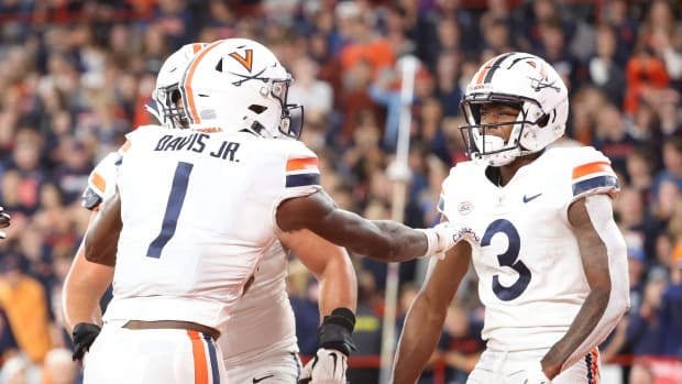 Virginia Cavaliers wide receivers Lavel Davis Jr. and Dontayvion Wicks celebrate a touchdown against the Syracuse Orange at the JMA Wireless Dome.