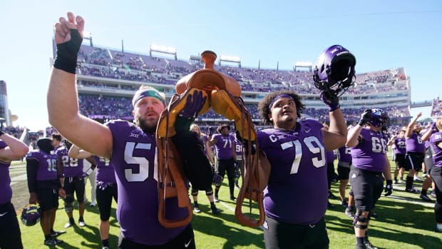 Nov 5, 2022; Fort Worth, Texas, USA; TCU Horned Frogs offensive lineman Alan Ali (56) and center Steve Avila (79) hold the Saddle Trophy following a game against the Texas Tech Red Raiders at Amon G. Carter Stadium. Mandatory Credit: Raymond Carlin III-USA TODAY Sports