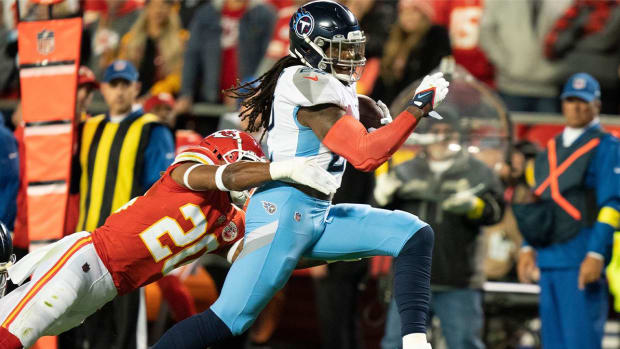 Tennessee Titans running back Derrick Henry (22) races past Kansas City Chiefs safety Justin Reid (20) during the second quarter at GEHA Field at Arrowhead Stadium Sunday, Nov. 6, 2022, in Kansas City, Mo.