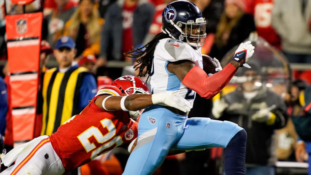 Tennessee Titans running back Derrick Henry (22) rushes for a first down past Kansas City Chiefs safety Justin Reid (20) during the second quarter at GEHA Field at Arrowhead Stadium Sunday, Nov. 6, 2022, in Kansas City, Mo.