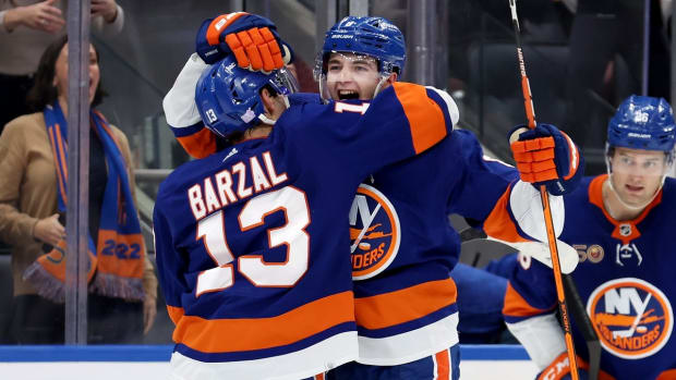 Nov 7, 2022; Elmont, New York, USA; New York Islanders defenseman Noah Dobson (8) celebrates with center Mathew Barzal (13) after scoring the game winning overtime goal against the Calgary Flames at UBS Arena. Mandatory Credit: Brad Penner-USA TODAY Sports