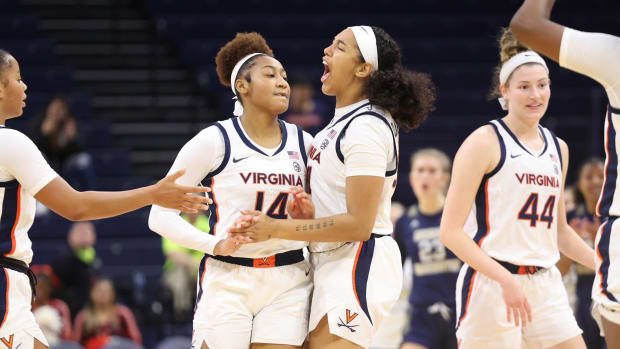 Kaydan Lawson and London Clarkson celebrate during the Virginia women's basketball game against George Washington at John Paul Jones Arena.