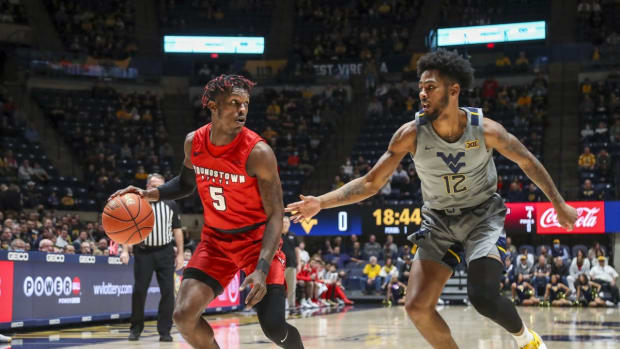 Dec 22, 2021; Morgantown, West Virginia, USA; Youngstown State Penguins guard Dwayne Cohill (5) attempts to drive baseline against West Virginia Mountaineers guard Taz Sherman (12) during the first half at WVU Coliseum. Mandatory Credit: Ben Queen-USA TODAY Sports
