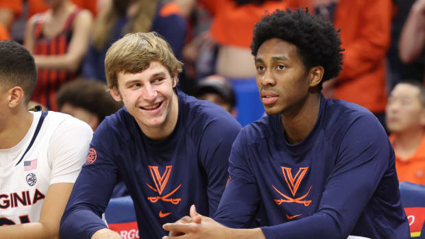 Isaac Traudt and Leon Bond look on during the Virginia men's basketball game against Monmouth at John Paul Jones Arena.