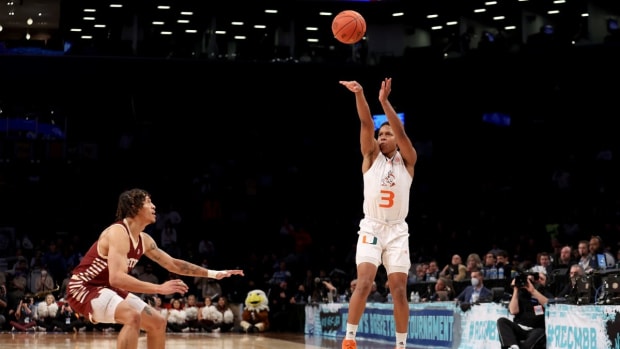 Mar 10, 2022; Brooklyn, NY, USA; Miami Hurricanes guard Charlie Moore (3) shoots a three point shot against Boston College Eagles guard Makai Ashton-Langford (11) during overtime at Barclays Center. Mandatory Credit: Brad Penner-USA TODAY Sports