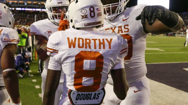 Nov 5, 2022; Manhattan, Kansas, USA; Texas Longhorns wide receiver Xavier Worthy (8) is congratulated by teammates after scoring a touchdown in the second quarter against the Kansas State Wildcats at Bill Snyder Family Football Stadium. Mandatory Credit: Scott Sewell-USA TODAY Sports