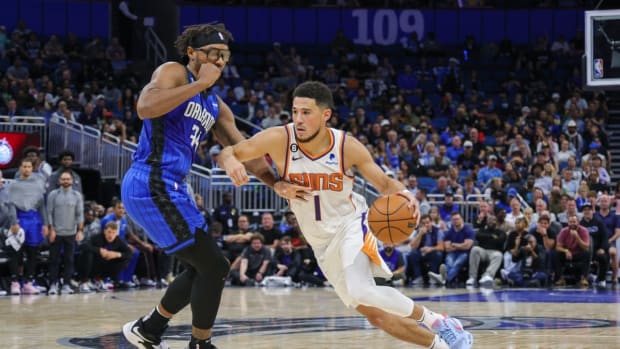 Nov 11, 2022; Orlando, Florida, USA; Phoenix Suns guard Devin Booker (1) drives to the basket in front of Orlando Magic center Wendell Carter Jr. (34) during the second half at Amway Center. Mandatory Credit: Mike Watters-USA TODAY Sports