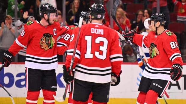 Nov 1, 2022; Chicago, Illinois, USA; Chicago Blackhawks forward Jonathan Toews (19) celebrates with forward Patrick Kane (88), forward Max Domi (13) and defenseman Caleb Jones (82) after scoring a power play goal in the third period against the New York Islanders at the United Center. New York defeated Chicago 3-1. Mandatory Credit: Jamie Sabau-USA TODAY Sports