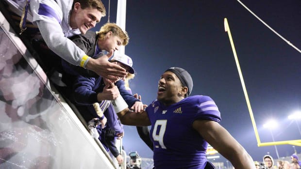 Michael Penix Jr. shares his good fortune with Husky fans.