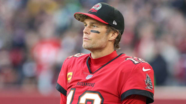 Buccaneers quarterback Tom Brady looks on from the sidelines without a helmet during a game in Germany vs. the Seahawks.