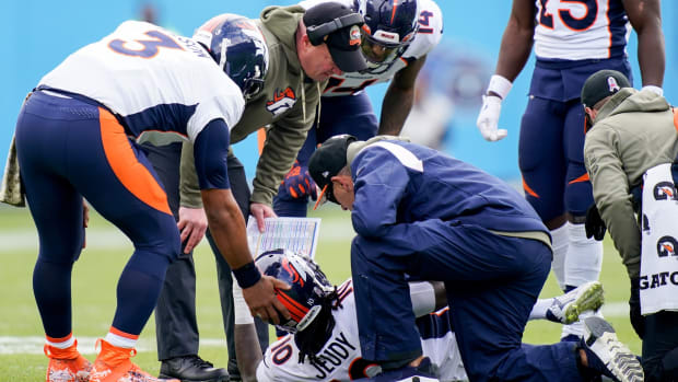 Denver Broncos wide receiver Jerry Jeudy (10) is checked after getting injured in the first quarter at Nissan Stadium.