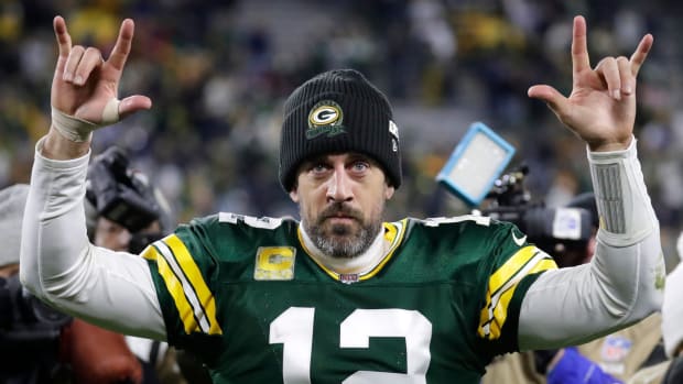 Green Bay Packers quarterback Aaron Rodgers (12) acknowledges the fans as he leaves the field following an overtime victory against the Dallas Cowboys during their football game Sunday, November 13, at Lambeau Field in Green Bay, Wis.
