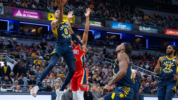 Nov 7, 2022; Indianapolis, Indiana, USA; Indiana Pacers guard Tyrese Haliburton (0) dribbles the ball whileNew Orleans Pelicans guard CJ McCollum (3) defends in the second half at Gainbridge Fieldhouse. Mandatory Credit: Trevor Ruszkowski-USA TODAY Sports
