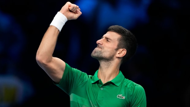 Novak Djokovic celebrates after winning against Stefanos Tsitsipas during their singles tennis match of the ATP World Tour Finals in Italy.