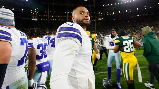 Cowboys quarterback Dak Prescott (4) looks around on the field following the game against the Packers at Lambeau Field.