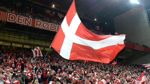 Danish soccer fan waves a Denmark flag during a World Cup qualifying match.