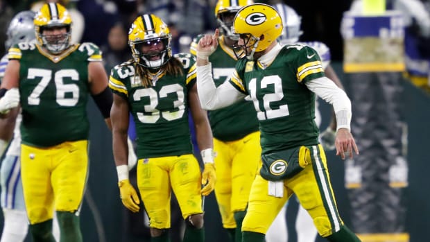Green Bay Packers quarterback Aaron Rodgers (12) celebrates throwing a touchdown to wide receiver Christian Watson (9) against the Dallas Cowboys during their football game Sunday, November 13, at Lambeau Field in Green Bay, Wis.