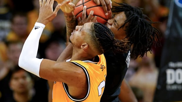 Cincinnati Bearcats forward Kalu Ezikpe (1) and Northern Kentucky Norse forward Chris Brandon (21) compete for a rebound in the first half during a college basketball game, Wednesday, Nov. 16, 2022, at Truist Arena in Highland Heights, Ky. Cincinnati Bearcats At Northern Kentucky Norse Nov 16 0099