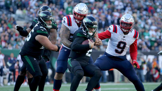 Oct 30, 2022; East Rutherford, New Jersey, USA; New York Jets quarterback Zach Wilson (2) is sacked by New England Patriots defensive end Lawrence Guy (93) and linebacker Matthew Judon (9) during the fourth quarter at MetLife Stadium.