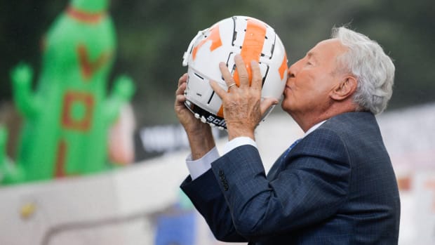 Lee Corso kisses a Tennessee football helmet during “College GameDay” in Knoxville, Tenn.